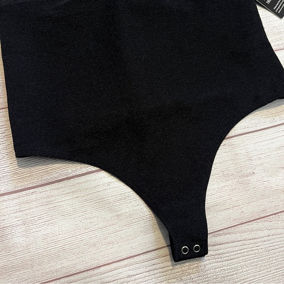 EXPRESS Ribbed Plunge Neck Bow Back Thong Bodysuit - Picture 6 of 16